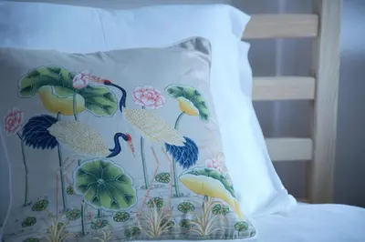 a pillow with a bird design on a bed at Pimenta Funchal Downtown in Funchal