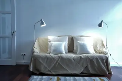 a white bed with two pillows on it in a room at Pimenta Funchal Downtown in Funchal