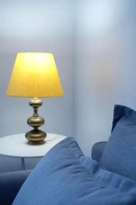 a lamp sitting on a table next to a bed at Pimenta Funchal Downtown in Funchal