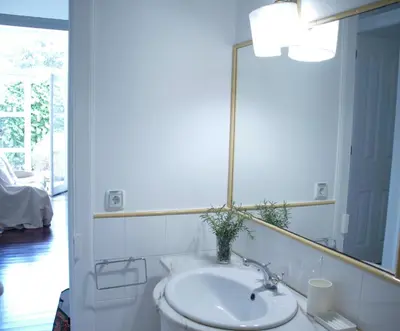 a bathroom with a sink and a mirror at Pimenta Funchal Downtown in Funchal