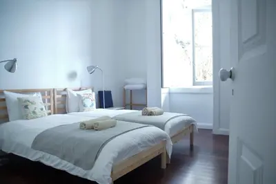 a bedroom with two beds with towels on them at Pimenta Funchal Downtown in Funchal