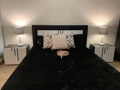 a bedroom with a large bed with two night stands at Giesta Flower by Madeira Holiday Rentals in Ribeira Brava