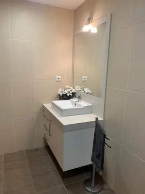 a bathroom with a white sink and a mirror at Giesta Flower by Madeira Holiday Rentals in Ribeira Brava