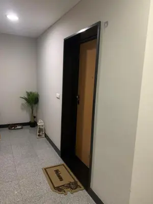 a hallway with a black door and a welcome mat at Giesta Flower by Madeira Holiday Rentals in Ribeira Brava
