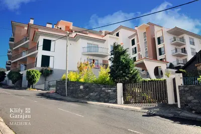 a building on the side of a street at Klify Garajau in Caniço