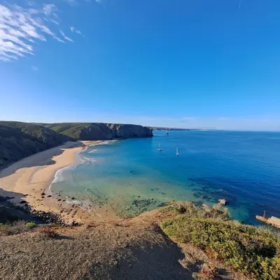 an aerial view of a beach in the ocean at Falésias da Arrifana in Praia da Arrifana