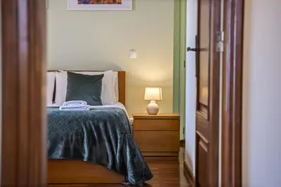 a bedroom with a bed and a lamp on a night stand at Sea View Apartment in Santa Cruz