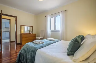 a bedroom with a bed with two towels on it at Sea View Apartment in Santa Cruz