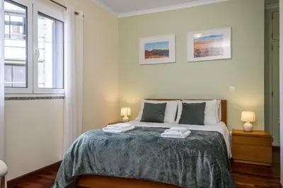 a bedroom with a bed with two towels on it at Sea View Apartment in Santa Cruz