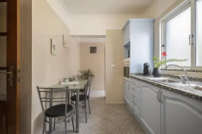 a kitchen with a table and chairs and a sink at Sea View Apartment in Santa Cruz