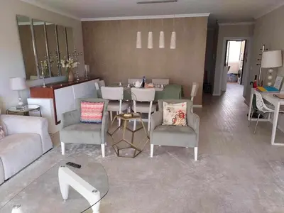 a living room with a couch and a table and chairs at GuestReady - Nora Premium in Funchal