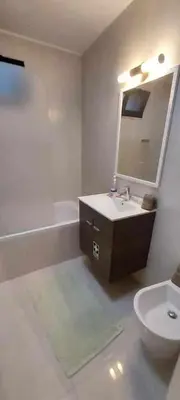 a bathroom with a sink and a toilet and a mirror at GuestReady - Nora Premium in Funchal