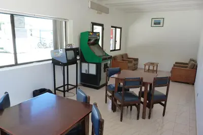 a room with a table and a video game at Parque de Campismo Orbitur Sagres in Sagres