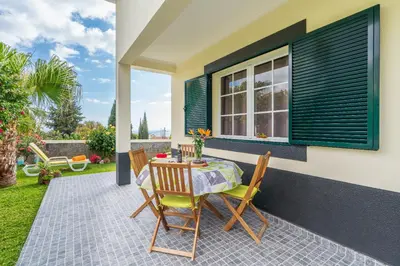 a table and chairs on the patio of a house at Casa Ventura in Arco da Calheta