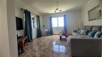 a living room with a couch and a tv at Casa Ventura in Arco da Calheta