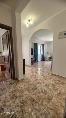 an empty living room with a large tile floor at Casa Ventura in Arco da Calheta