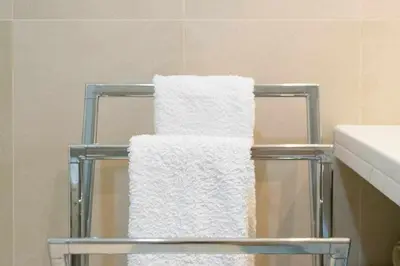 three towels on a towel rack in a bathroom at Dolce Vita - City Center & Shopping Center in Funchal