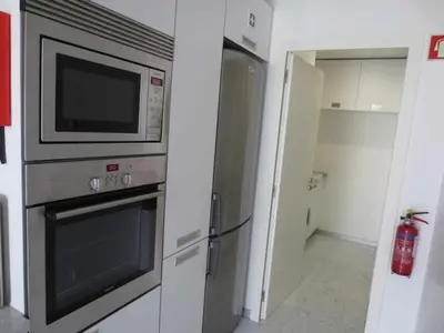a kitchen with a microwave and a refrigerator at Dolce Vita - City Center & Shopping Center in Funchal