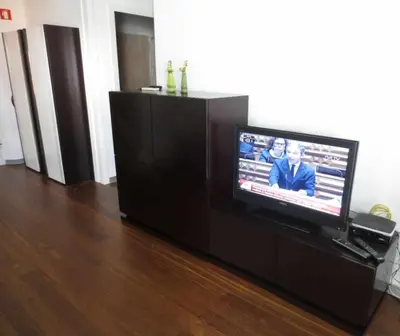 a flat screen tv sitting on a entertainment center at Dolce Vita - City Center & Shopping Center in Funchal