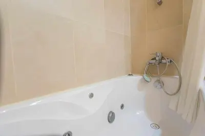 a white bath tub in a bathroom with a shower at Dolce Vita - City Center & Shopping Center in Funchal