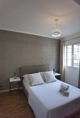 a bedroom with a large bed with white sheets at Old City Apartment in Funchal