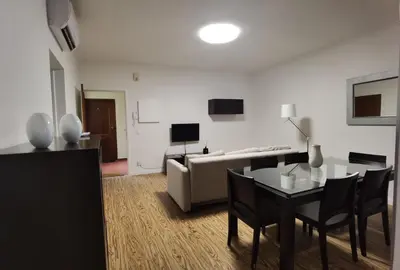 a living room with a table and a couch at Old City Apartment in Funchal