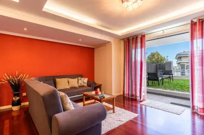 a living room with a couch and a table at Casa Branca with garden by Holiday Rental Madeira in Funchal