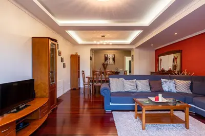 a living room with a blue couch and a table at Casa Branca with garden by Holiday Rental Madeira in Funchal