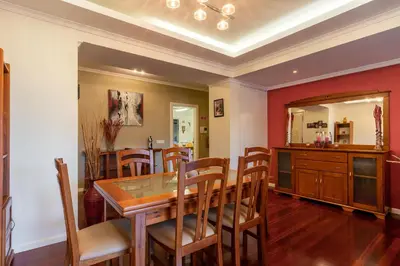 a dining room with a wooden table and chairs at Casa Branca with garden by Holiday Rental Madeira in Funchal