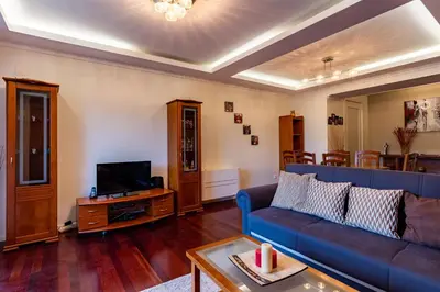 a living room with a blue couch and a tv at Casa Branca with garden by Holiday Rental Madeira in Funchal