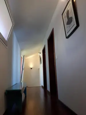 a hallway with a table and a picture on the wall at Au petit Madère in Prazeres