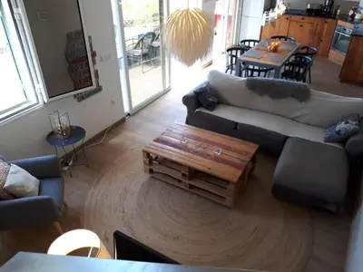 a living room with a couch and a coffee table at Au petit Madère in Prazeres