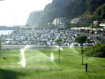 a parking lot filled with lots of parked cars at Apartamento do Sol in Arco da Calheta