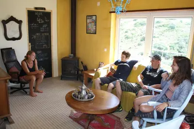 a group of people sitting in a room at Hostel on the Hill in Raposeira
