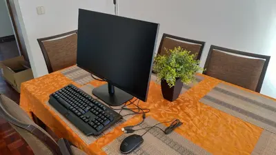 a computer monitor and a keyboard and mouse on a table at Jardins Piornais Funchal Apartment in Funchal