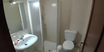 a bathroom with a shower and a toilet and a sink at Jardins Piornais Funchal Apartment in Funchal