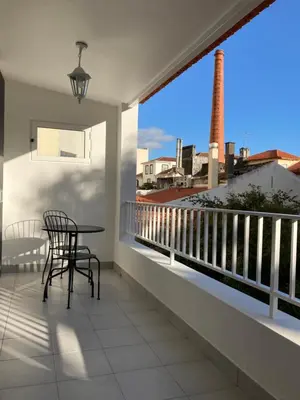 a balcony with a table and chairs and a view at Museum House in Funchal