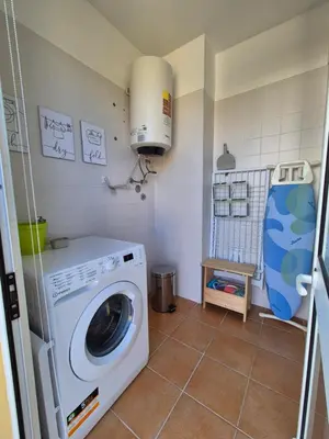 a laundry room with a washing machine in it at Cantinho do Porto Santo in Porto Santo