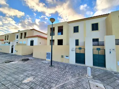a building with a street light in a parking lot at Cantinho do Porto Santo in Porto Santo