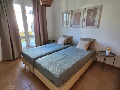 a bedroom with a bed and a window at Cantinho do Porto Santo in Porto Santo