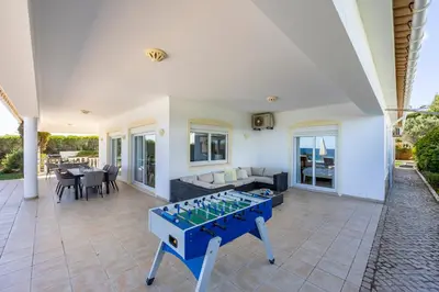 a living room with a ping pong table at Villa Zinha in Luz