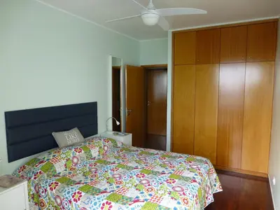 a bedroom with a large bed and wooden cabinets at Shearwaternest 2 Apartment in Funchal