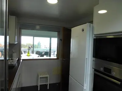 a kitchen with a white refrigerator and a window at Shearwaternest 2 Apartment in Funchal