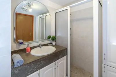 a bathroom with a sink and a mirror at Apartamento Rodrigues in Funchal