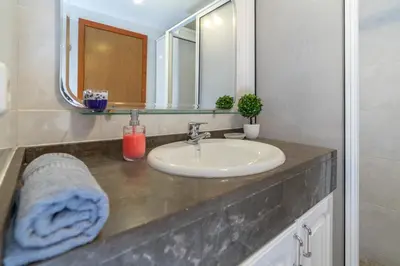a bathroom with a sink and a mirror at Apartamento Rodrigues in Funchal