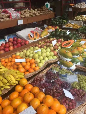 a display of fruits and vegetables in a market at Charming Apartments in Funchal - São Gonçalo in Funchal
