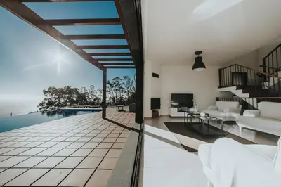 an open living room with a view of the pool at Ocean View Villa in Funchal
