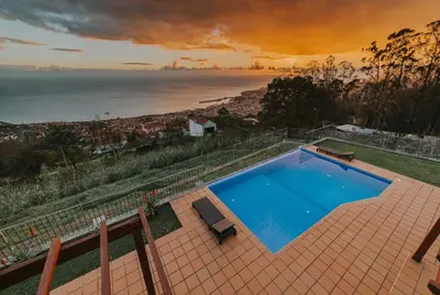 a swimming pool with a view of the ocean at Ocean View Villa in Funchal