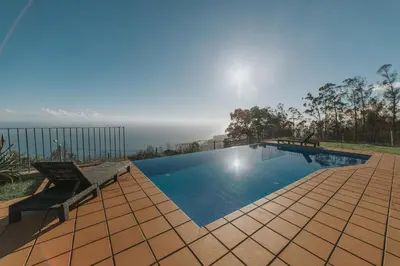 a swimming pool with a view of the ocean at Ocean View Villa in Funchal