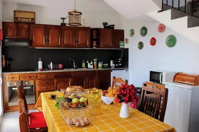 a kitchen with a table with a basket of food at Quinta Terezinha in Ribeira Brava